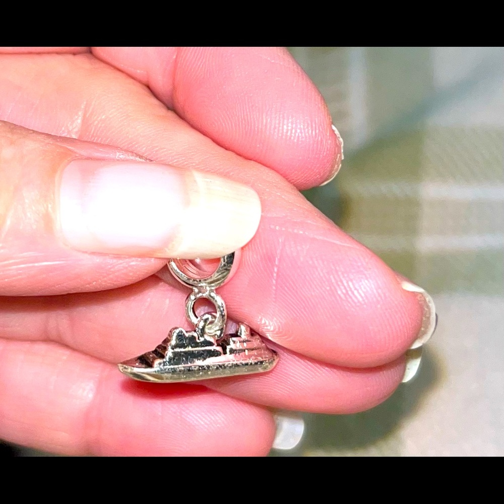 Silver tone cruise ship charm.